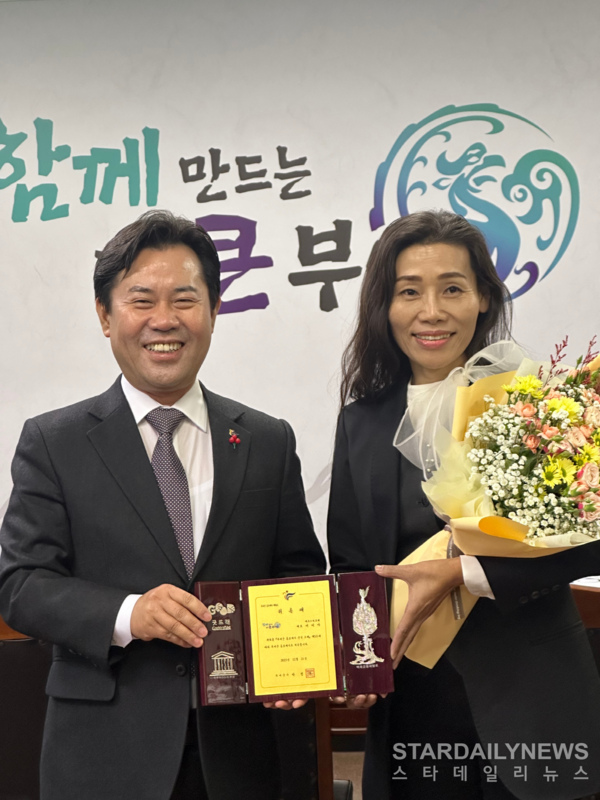 박정현 부여군수(왼쪽)이 이미아 대표에게 홍보대사 위촉장을 주고 있다. (사진: 부여군 제공)